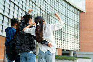 Group of happy young entrepreneurs with hands up and laughing to celebrate and excited success for achievements obtained. Undergraduate students celebrate success after end project, teamwork concept photo