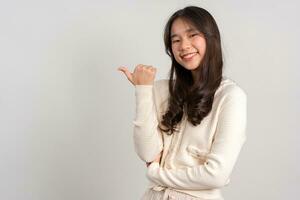 Portrait of attractive cheerful girl demonstrating and pointing finger to the side empty space isolated white background, showing advertisement, standing against. Advertisement presentation concept photo