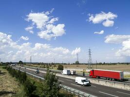 cars trucks person and stocks on motorway photo