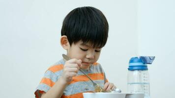 Asian boy Eating noodles on the table video