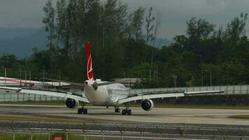 PHUKET, THAILAND JANUARY 26, 2023 - Airbus A330303, TCLNG of Turkish Airlines taxiing to the airport terminal after landing in Phuket. Spoilers up, braking video