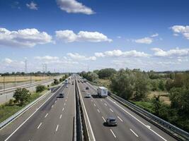 cars trucks person and stocks on motorway photo