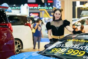 Nonthaburi, Thailand - MAR 26, 2023 Unidentified model poses with a car at The 44th Bangkok international motor show 2023 at IMPACT Arena, Muang Thong Thani, Nonthaburi, Thailand. photo