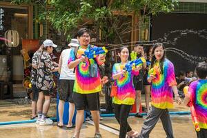 Siam Square, Bangkok, Thailand - APR 13, 2023 Songkran Festival, The short action of people joins celebrations of the Thai New Year or Songkran in Siam Square Bangkok, Thailand. photo