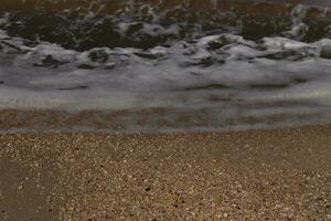 I loved the look of the ocean coming into the beach here. The sea foam slowly washing over the pretty pebbles some of which look like gems and are translucent all very smooth from being tumbled. photo