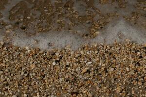 I loved the look of the ocean coming into the beach here. The sea foam slowly washing over the pretty pebbles some of which look like gems and are translucent all very smooth from being tumbled. photo