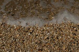 I loved the look of the ocean coming into the beach here. The sea foam slowly washing over the pretty pebbles some of which look like gems and are translucent all very smooth from being tumbled. photo