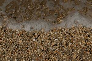 I loved the look of the ocean coming into the beach here. The sea foam slowly washing over the pretty pebbles some of which look like gems and are translucent all very smooth from being tumbled. photo