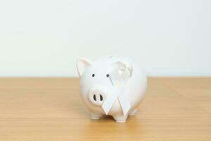 November Lung Cancer Awareness month, White Ribbon with Piggy Bank for support illness life. Health, Donation, Charity, Campaign, Money Saving, Fund and World cancer day concept photo