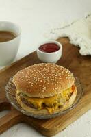 Delicious homemade hamburger on white wood table photo