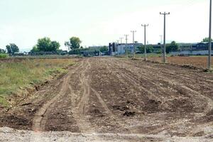 a dirt road with a fire hydrant on it photo