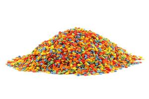 pile of colored sugar sprinkle dots isolated on white photo