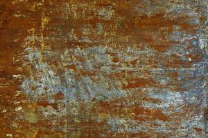 flat artistically rusted steel surface with leftovers of gray paing - full-frame background and texture photo