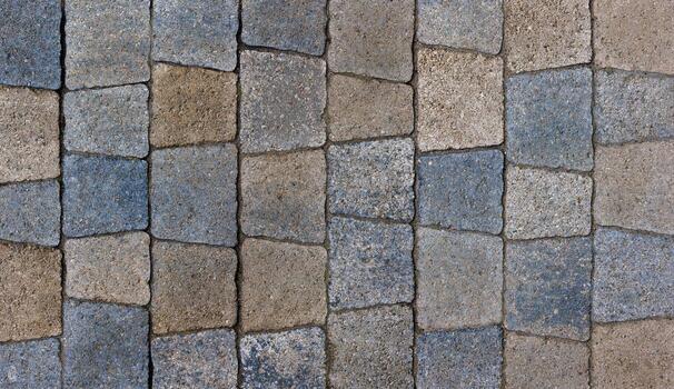 colored trapezoid concrete tiles pavement in high angle view - full frame background and texture photo