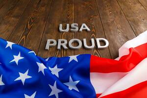 words USA proud laid with silver metal letters on brown wooden surface with flag of United States of America photo