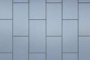 Outside wall of building covered with grayish blue painted metal rectangular panels - full-frame background and texture. photo