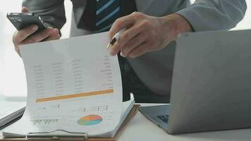 Finance Investment Ideas on Company Growth Project Success Statistics A professional investor working on starting a project for a strategic plan with a document, a laptop, on an office table. video