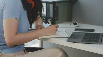 Charming Young asian businesswoman sitting on laptop computer in the office, making report calculating balance Internal Revenue Service checking document. video