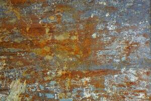flat artistically rusted steel surface with leftovers of gray paing - full-frame background and texture photo
