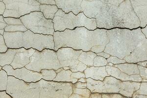 deep horizontal cracks on old wall plaster - full-frame texture and background photo