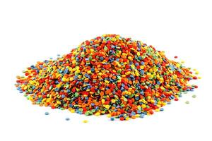 pile of colored sugar sprinkle dots isolated on white photo