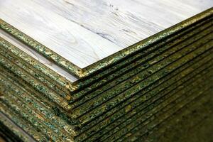 stacks of tongue and groove water resistant OSB compressed sawdust sheets photo