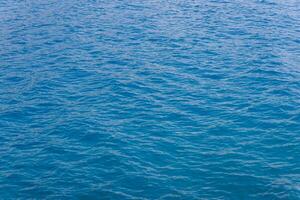 generic boundless sea water surface, only blue water at day time with mild ripple vawes photo