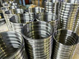stacks of turned shiny silver steel rings after CNC turning operations - close-up with selective focus photo