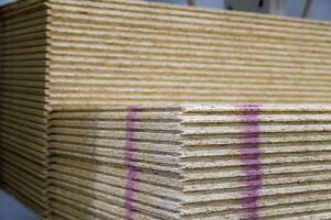 stacks of tongue and groove water resistant OSB compressed sawdust sheets photo