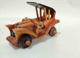 handmade wooden toy car on a white background photo