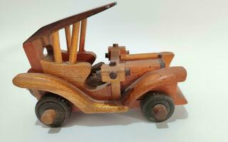 handmade wooden toy car on a white background photo