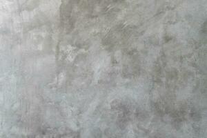 Old dirty grey concrete background texture used in decorative art work. Gray concrete wall texture with strange pattern and stripes photo