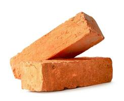 Cracked old red or orange bricks in stack isolated on white background with clipping path photo