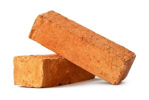 Cracked old red or orange bricks in stack isolated on white background with clipping path photo