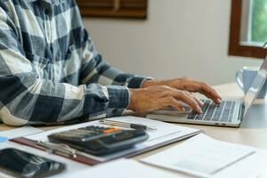 Attractive confident Hispanic Business man using laptop computer and professional working investor start up project business planning in office photo
