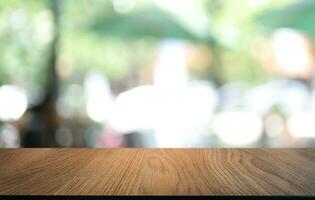 Empty wooden table in front of abstract blurred background of coffee shop . can be used for display or montage your products.Mock up for display of product photo