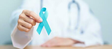 Blue November Prostate Cancer Awareness month, Doctor with Blue Ribbon in hospital for support people life and illness. Healthcare, International men, Father, Diabetes and World cancer day photo