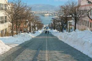 Hachiman Zaka Slope with Snow in winter season. landmark and popular for attractions in Hokkaido, Japan. Travel and Vacation concept photo