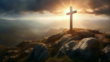 a cross on a mountain with the sun shining on it photo