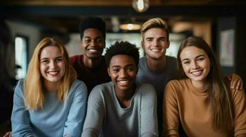 a group of young adults indoors smiling looking at camera photo