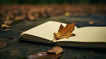 a notebook with a leaf on it and a pencil on the left side photo