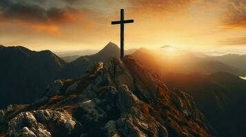christian cross on majestic mountain peak at sunset photo