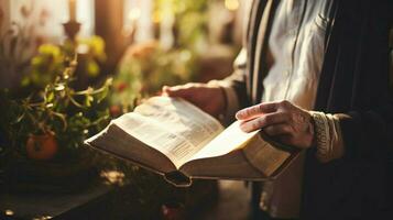 hand holding bible studying religious text indoors photo