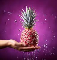 Pineapple in the hands with water splash. photo