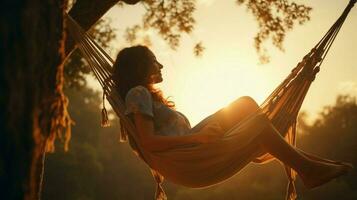 one woman swinging in hammock carefree relaxation photo