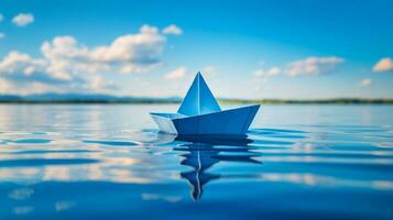 origami paper boat sails on blue water a creative journey photo