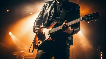 pop musician holding guitar performs on stage photo