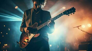 pop musician holding guitar performs on stage photo