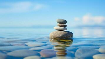 stone pebble balance on blue water background photo