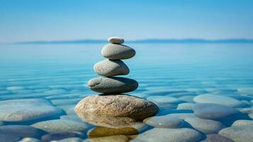 stone pebble balance on blue water background photo